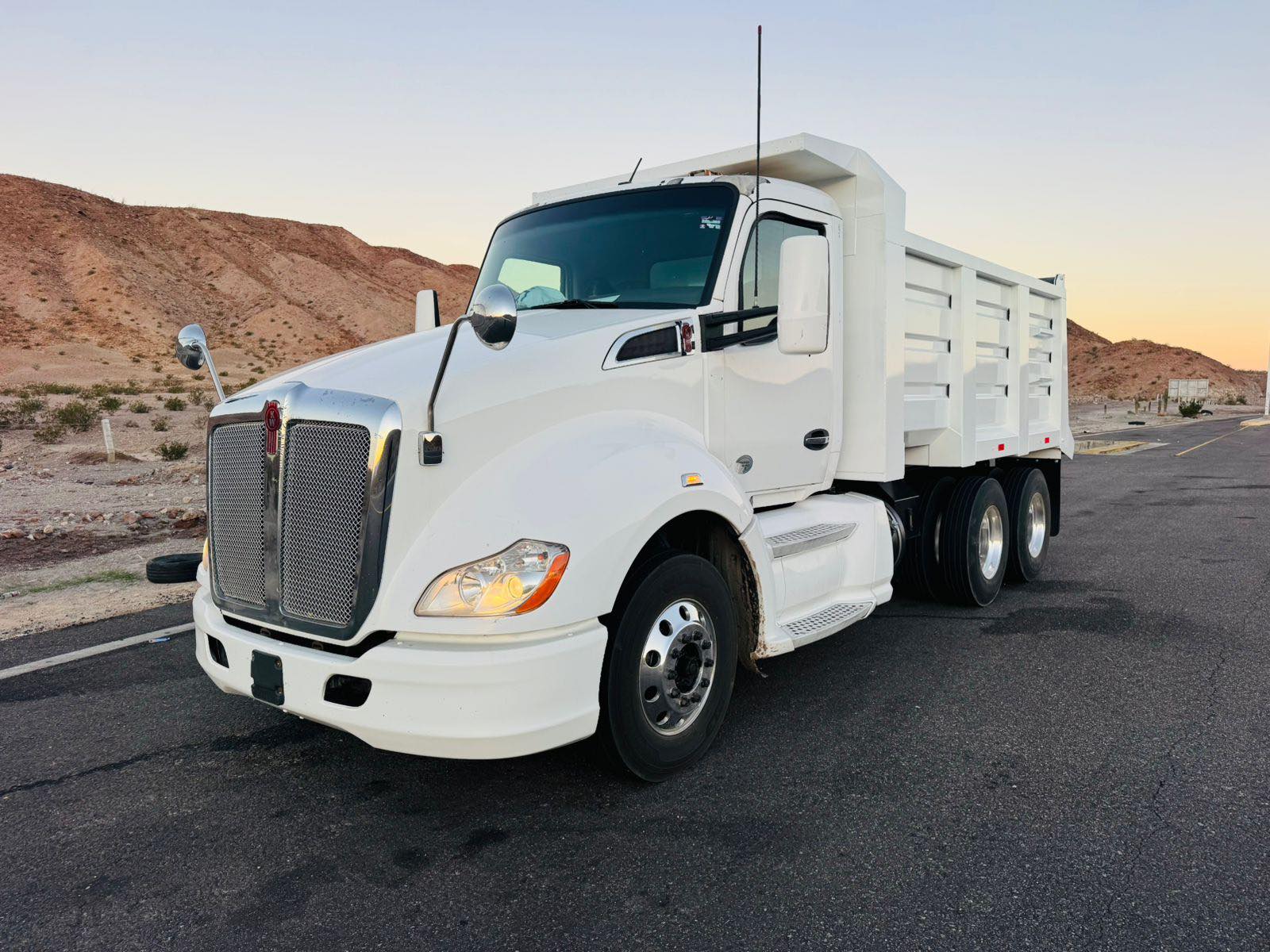 White dump truck with fabricated dump body on the road