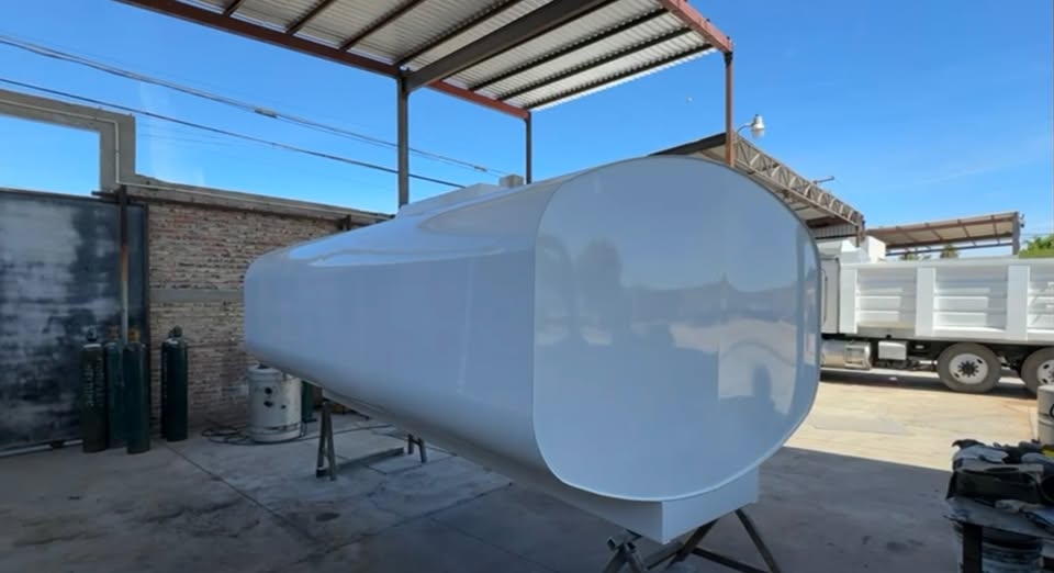 White fabricated water tank in MR Machinery shop area